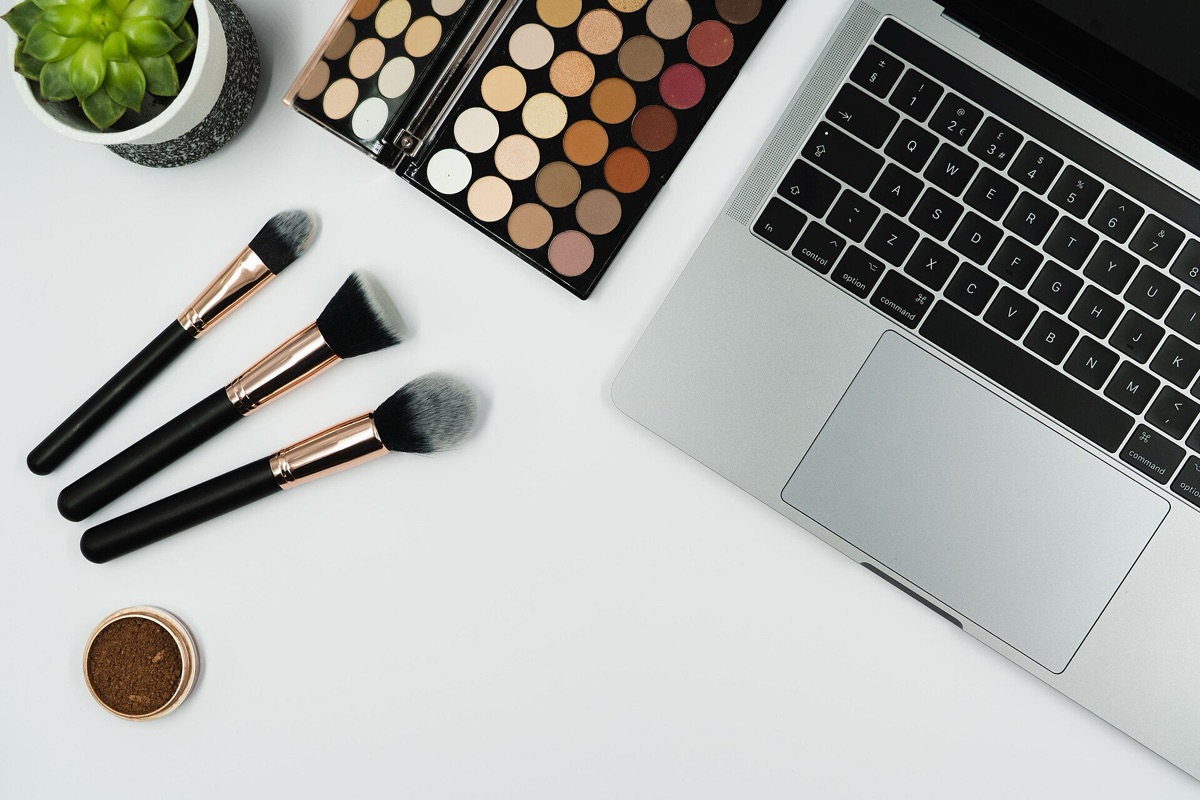 Professional makeup brushes and colorful eyeshadow palettes